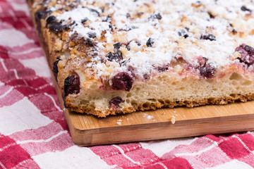 Grandmothers cake with cherries on the wooden board