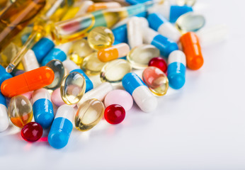 Medications tablets and capsules in a beaker