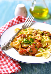 Farfalle with sausage in tomato sauce.