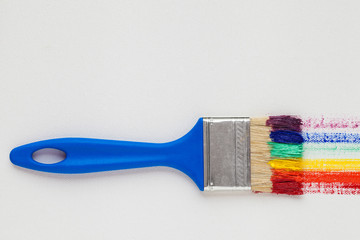 Paintbrush with blue handle and multicolor rainbow brush strokes