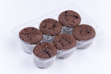 Bunch of brown chocolate muffins over white background