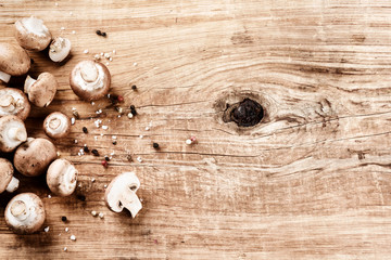 Cooking setting with fresh mushrooms on old wooden table
