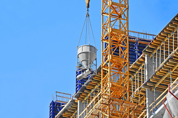 Fototapeta na wymiar Crane lifting cement mixing container