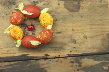 Colorful Easter eggs on an old, wooden background. Celebrating Easter holidays. Place for your text.
