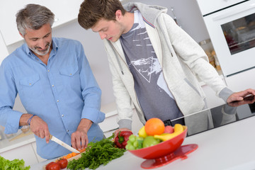 Father and son preparing vegetables