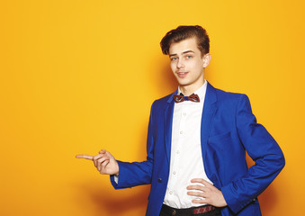 Sexy hipster boy in the jacket in the studio