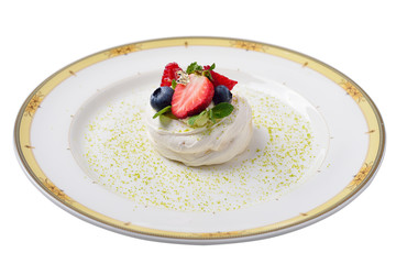 pavlova cake decorated with gold, raspberries, blueberries and m