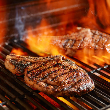 Ribeye Steaks On The Grill Over The Open Flame