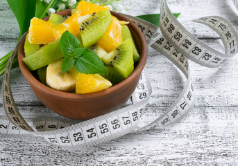 Fruit salad with kiwi, banana and orange for slimming and centim