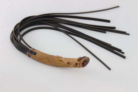 flogger with carved wooden handle