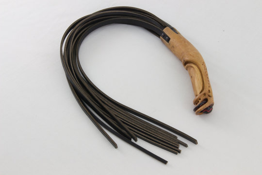 flogger with carved wooden handle