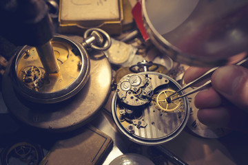 Watchmakers Craftmanship. A watch maker repairing a vintage automatic watch.