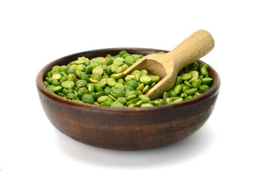 Split peas in wooden bowl isolated on white background