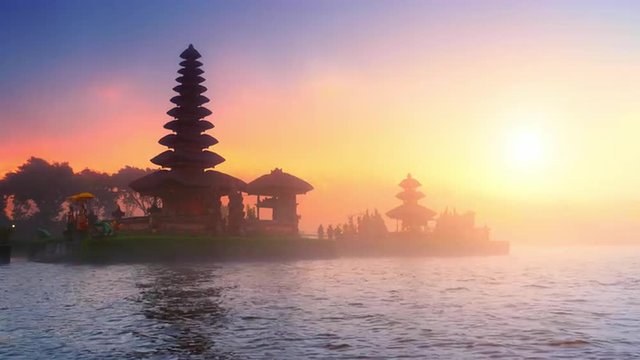 Bali temple silhouette and sunset sunshine over holy site in Indonesia