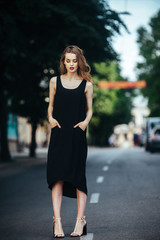 Fototapeta na wymiar pretty girl posing in a city street