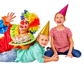 Clown keeps cake on birthday with two children. Isolated.