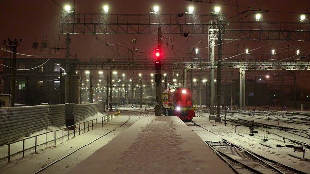 Diesel locomotive goes by train at night