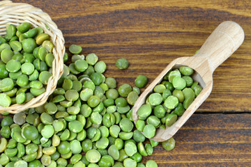 Lentils in wooden scoop on wooden table