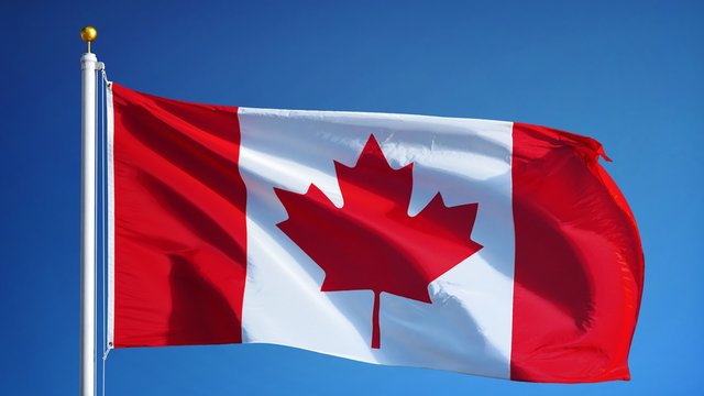 Canada flag waving in slow motion against blue sky, seamlessly looped, close up, isolated on alpha channel with black and white luminance matte, perfect for film, news, digital composition
