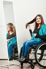 Invalid girl on wheelchair combing hair