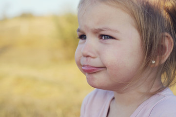 Fototapeta premium The little girl was crying, offended, upset and distressed.