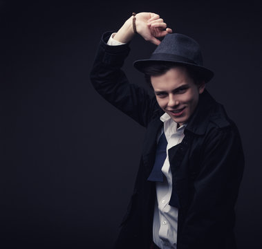 Vogue Handsome Man In The Hat And Untied Tie Bow In The Studio Portrait