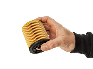 male hand holding a auto oil filter