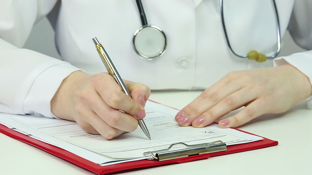 Reception hours at doctor's office, physician handing prescription to patient