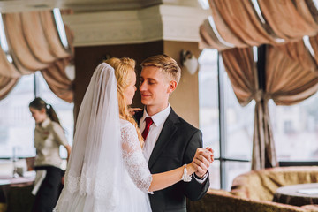 Happy bride and groom in royal vintage interior of restaurant