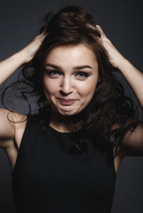 High fashion sensual girl in the black dress in the studio