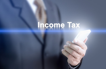 Businessman pressing hand Income Tax word on virtual screen. Can bring to the medium of your ad.