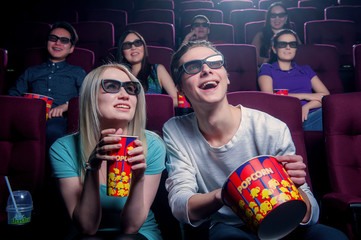 People in the cinema wearing 3d glasses
