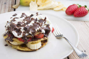 pancakes with strawberries, banana, blueberries and chocolate...