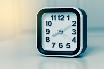 Modern alarm clock with sunlight in morning.