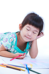 Child lie on the floor and drawing on paper.  On white
