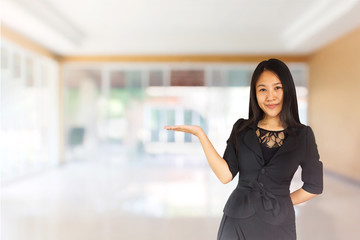 Smiling young Asian business women in black suit with hand prese