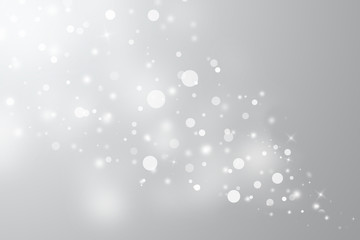 Gray glitter sparkles defocused rays lights bokeh abstract christmas background.