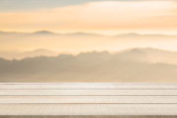 wood table top on blurred mountain landscape