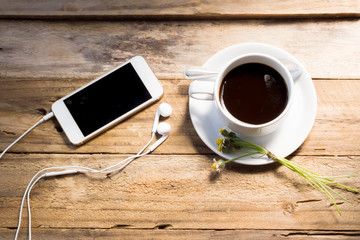 coffee cup and smart phone on wood table. modern office desktop