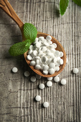 Analogue of sugar cubes and stevia  on grey wooden background