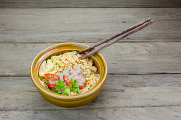 instant noodle in a bowl on a wooden background