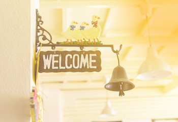 Sign welcome bell of the house. Vintage tone.