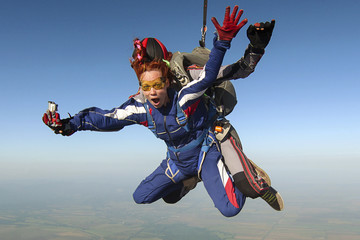 Tandem jump. The girl with the instructor in freefall.