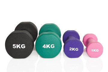Obraz na płótnie Canvas Fitness dumbbells. Black, green, purple and pink dumbbells isolated on white background. Weights for a fitness training.
