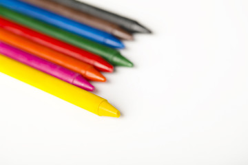 leadership concept, colorful oil pastel crayons on white background, selective focus