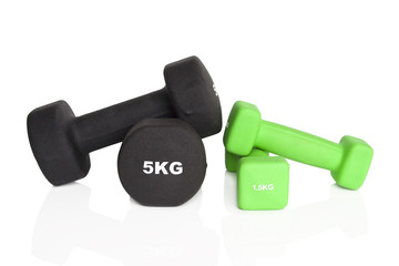 Fitness dumbbells. Green 1.5 kg and black 5 kg dumbbells isolated on white background. Weights for a fitness training.