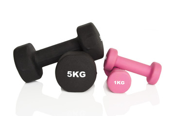 Fitness dumbbells. Pink 1 kg and black 5 kg dumbbells isolated on white background. Weights for a fitness training.