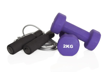 Home fitness equipment. Dumbbells and skipping rope isolated on white background. Weights for a fitness training.