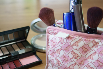 The Set of cosmetic bag on wood background