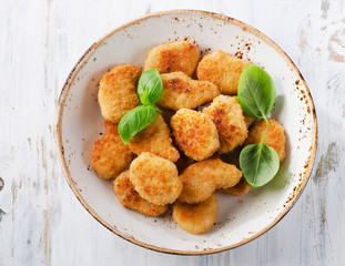 Crispy chicken nuggets on a plate.
